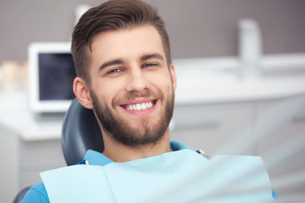 Portrait of happy patient in dental chair